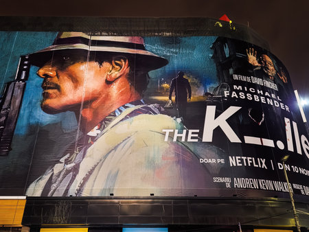 Bucharest, Romania - November 02 2023: The Killer Netflix movie poster with Michael Fassbender directed by David Fincher giant street banner with Romanian titles.のeditorial素材