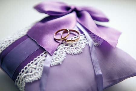 Weddings ring on the serenity pillow on a white backgroundの写真素材