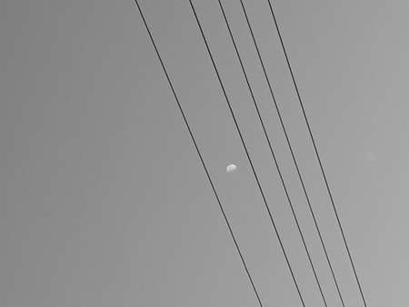 Moon between the wiresの写真素材