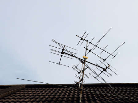 Antenna on the roof above the blue skyの写真素材