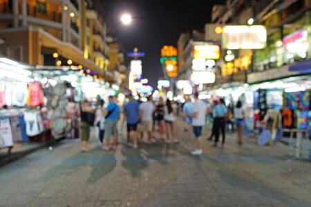 Travelers stands at night market in blur modeの写真素材