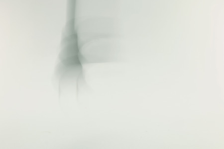a moving swinging plug in grey tone backgroundの写真素材