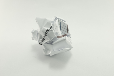 wrinkled crumpled marketing report paper ball in dark toneの写真素材