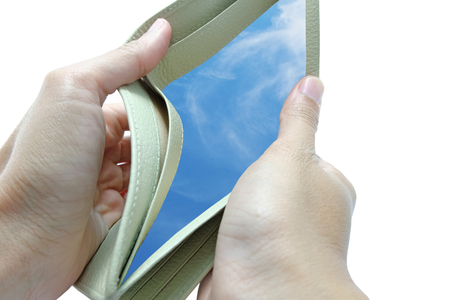 The wallet is opened by both hand in white background and found the light blue sky with cloudの写真素材