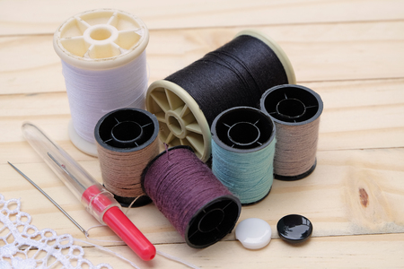 Embroidery Equipmentneedle,thread,buttons and lace with wood floorの写真素材