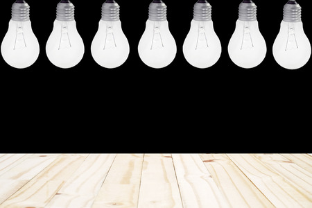 wood plain outreaches with light bulbs hang on ceiling with black backgroundの写真素材