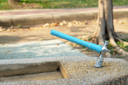water tap in the park with grit stones sink in the public gardenの写真素材