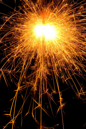 Hot orange burning  sparkler at nightの写真素材