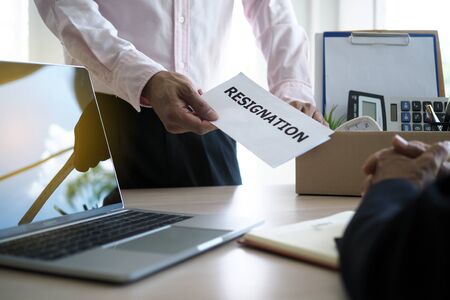 businessman have boxes for personal use and are sending resignation letters to executives. Including about resignation from job positions and vacancies.の写真素材