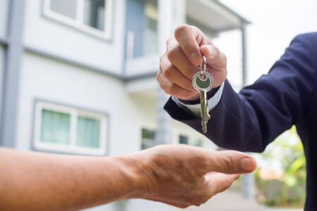 Home buyers are taking home keys from sellers.の写真素材