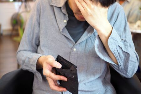 Man's hands open empty purse. Poverty, debt and bankruptcy in the payment of bills and credit cards. Broke conceptの写真素材