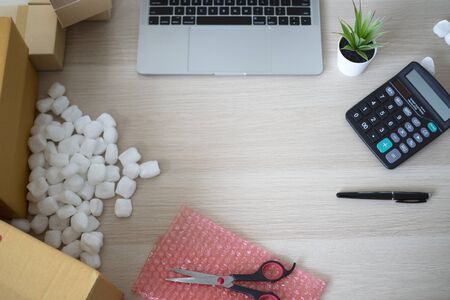 Small business desks in online sales, cardboard parcel boxes of products for delivery to customers.の写真素材