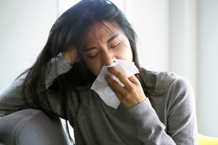 Asian women have high fever and runny nose. sick people concept
