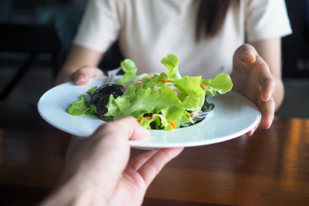 Women are happy to eat salad as a dinner for good health and Good shape.