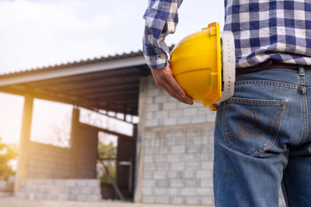 Engineers or contractors working on building sites in hand holding hard-hat. Engineering and...