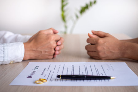 The hands of the wife and husband with the order of divorce, dissolution, cancellation of marriage,...