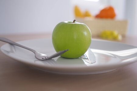 Green apples in a plateの写真素材