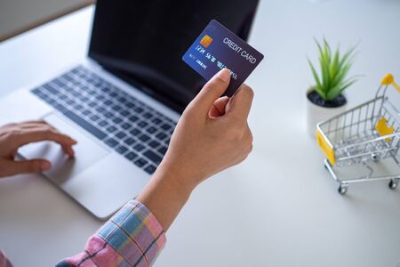 woman use credit card for shopping and payment online on computer.の写真素材