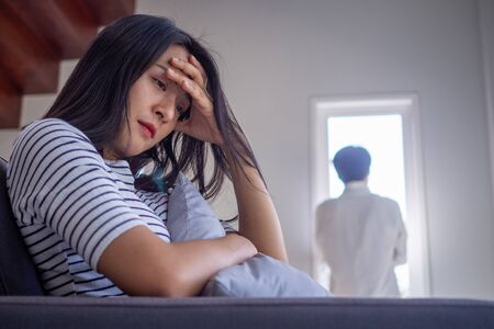 Asian women mourn and become irritated by their husband's behavior. After an argument and causing pain in the heart. Angry and not understanding each other, resulting to divorceの写真素材