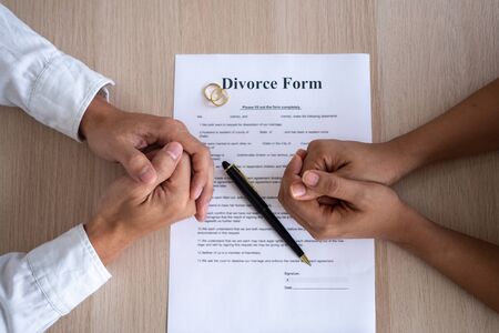 The hands of the husband and wife with the divorce paperの写真素材