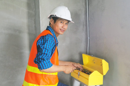 The inspector or engineer is inspecting and measuring the size of the building terrace.