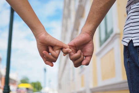 Young man holding a girl and walked together.の写真素材