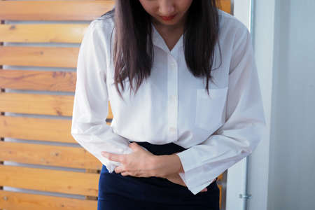 Middle-aged working women have abdominal pain like indigestion. Gestroesophangeal Reflux Diseaseの写真素材