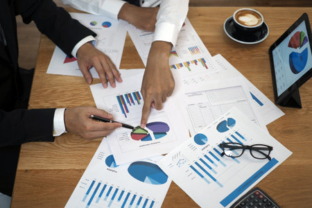 Brainstorming stock market investment plans. With statistical data showing profits and income....