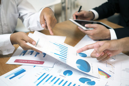 Brainstorming stock market investment plans. With statistical data showing profits and income....
