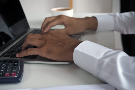 Businessmen use the keyboard on the desk.