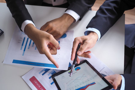 Asian consultants analyze and discuss current economic situation. Get financial advice and invest in...