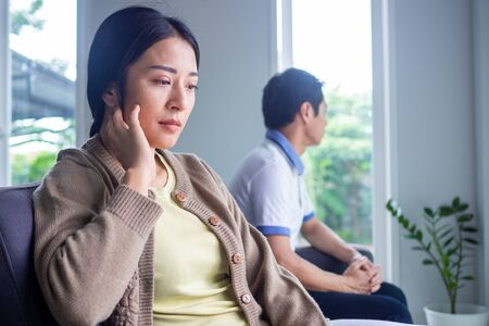 The woman felt depressed, upset and sad after fighting with her husband's bad behavior. Unhappy young wife bored with problems after marriage.の写真素材