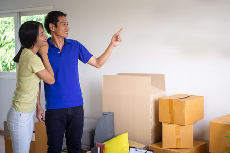 A happy young couple is moving to a new home.