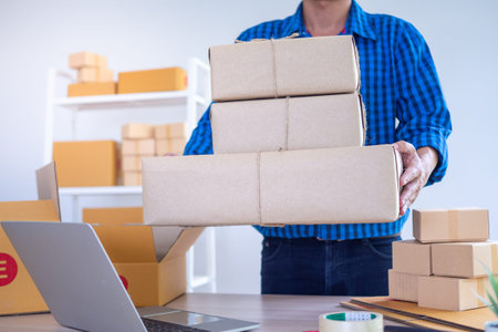 A young business owner with a box to send products to customers. Online sellers accept orders...