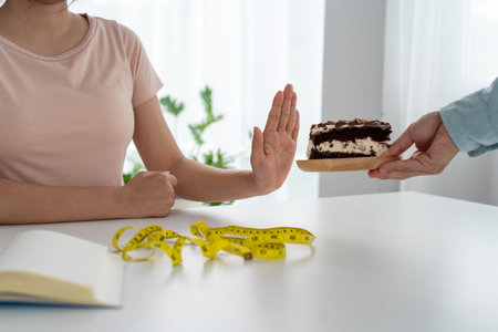Skinny women refuse to eat chocolate cake. Women do not eat trans fats and sugar. diet concept