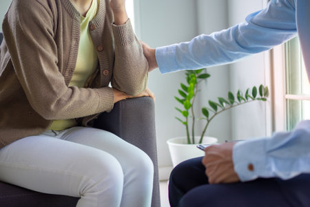 Psychologists treat young women with mental illness. Doctors in counsel and encouragement to a depressed and stressed young woman. Mental health conceptの写真素材