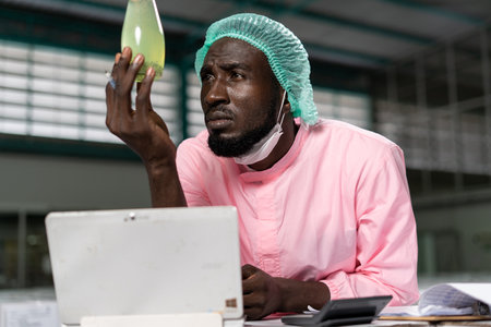 Quality control engineer. Workers in the factory write down notes about bottles or gallons before send to customers. Inspection quality control in food factory.の写真素材