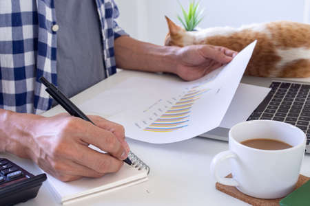 Man using a laptop at home to work or study online to prevent the spread of the virus. Work from home, study online conceptsの写真素材