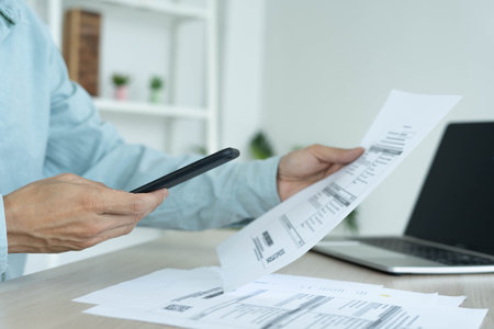 A businessman uses a smartphone to scan barcode by connecting to the internet from 5G signal to...