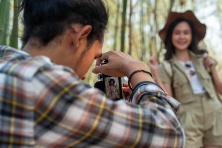Male and female tourists are touring nature and taking pictures of the scenery. Couples go wild...