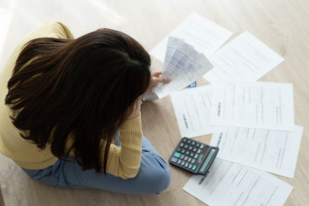 Women stress about a lot of credit card debt and bills on the floor. The housewife has trouble...