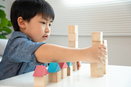 Child play with toy blocks.  Asian boys enjoy playing with building blocks. Educational game for baby and toddler to home preschool, school, kindergarten or nursery. Portrait child or little kidの写真素材
