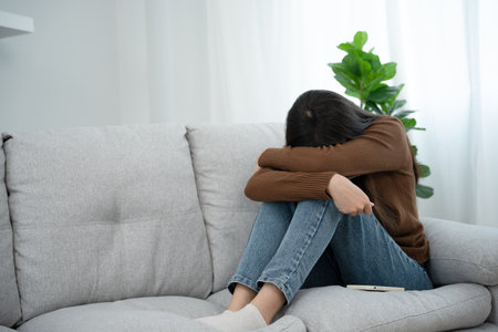 Depression and mental illness. Beautiful Asian woman disappointed and sad after receiving bad news. Stressed girl confused with unhappy problems in life, arguing with her boyfriend.の写真素材
