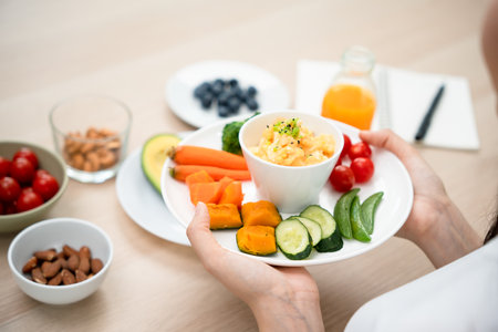 women enjoy the keto diet for weight loss and slimming. Correct nutrition Cereals, almonds, avocados, juices, tomatoes, egg white salad for diet planの写真素材