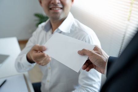 Businessmen receive salary or bonuses from management or Boss. Company give rewards to encourage work. Smiling businessman enjoying a reward at the desk in the office.の写真素材