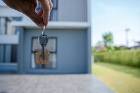 Selling home ,Landlord and New home. The house key for unlocking a new house is plugged into the door. Mortgage, rent, buy, sell, move home conceptの写真素材