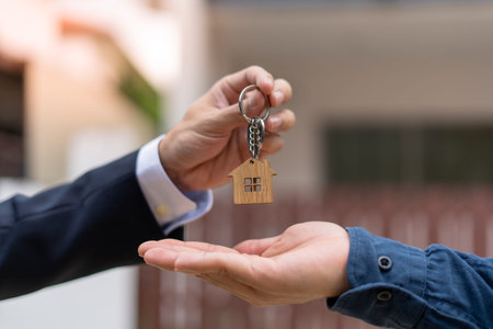 Home buyers are taking home keys from sellers. Deal contract complete. Sell your house, rent house...