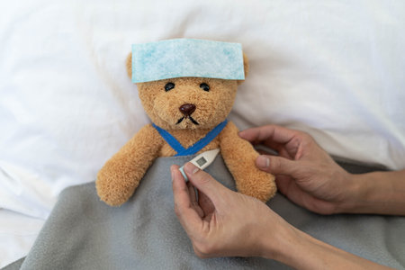 Teddy bear and bandage with thermometer. sick and injury concept