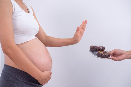 Pregnant women strive to control their sugar so they don't develop diabetes during pregnancy.  Pregnant women refuse to eat donuts and foods containing caffeine.の写真素材