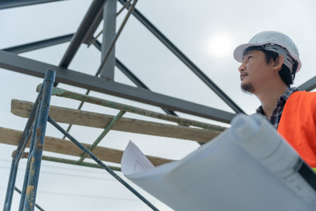 Engineers use blueprint check construction on site. Contractor and inspector inspection construction during project.civil Forman check quality assurance. Audit, inspect, quality control.の写真素材